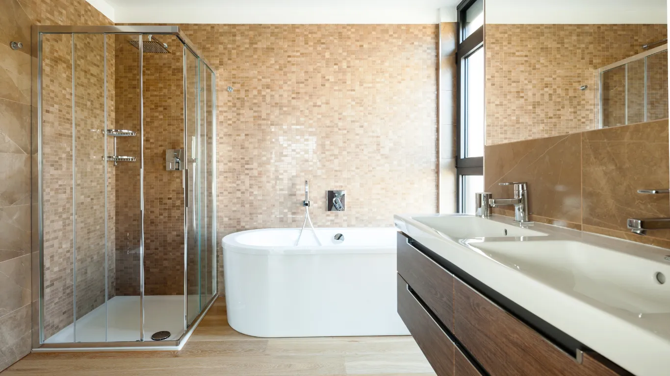 Bathroom remodeling project in Los Angeles with walk-in glass shower, freestanding bathtub, double vanity, tile walls, modern fixtures, and spa-style bathroom design